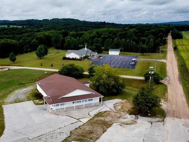 birds eye view of property featuring a wooded view