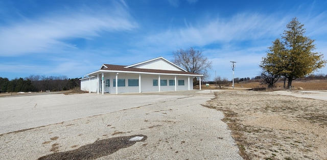 view of front of home with aphalt driveway and a porch