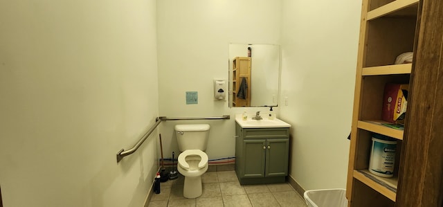 bathroom featuring tile patterned floors, baseboards, toilet, and vanity