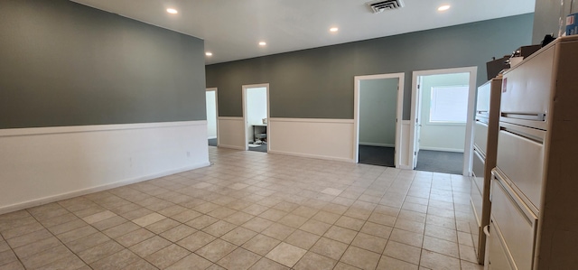 spare room featuring light tile patterned floors, recessed lighting, visible vents, and baseboards