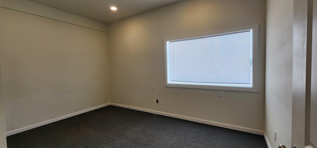 empty room with recessed lighting and baseboards