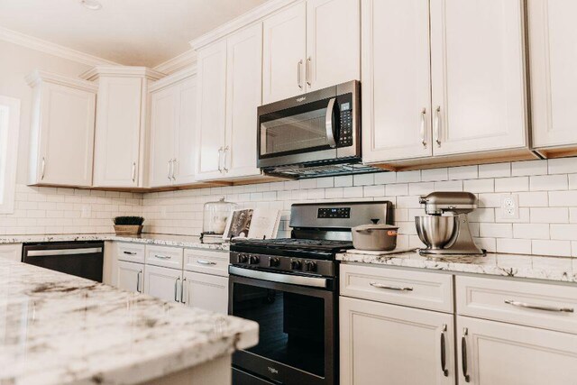 5227 Brinson Ln, Kalamazoo, MI 49009 - kitchen with decorative backsplash, crown molding, white cabinetry, and stainless steel appliances
