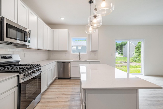 5227 Brinson Ln, Kalamazoo, MI 49009 - kitchen featuring appliances with stainless steel finishes, a kitchen island, light wood-style flooring, light countertops, and recessed lighting