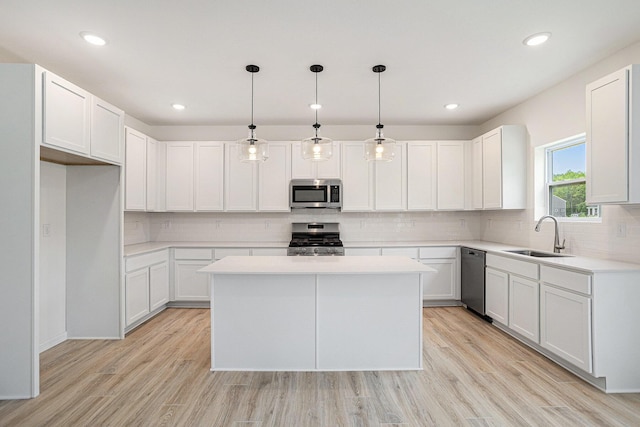 5227 Brinson Ln, Kalamazoo, MI 49009 - kitchen with appliances with stainless steel finishes, a kitchen island, tasteful backsplash, light countertops, and recessed lighting