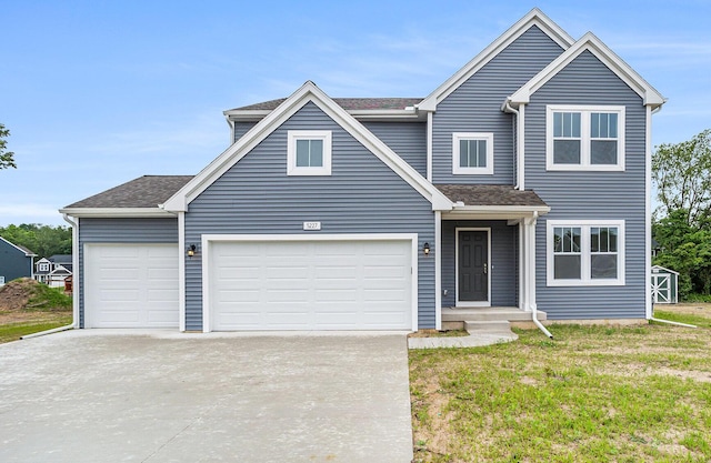 5227 Brinson Ln, Kalamazoo, MI 49009 - traditional home featuring concrete driveway, a front yard, an attached garage, and a shingled roof