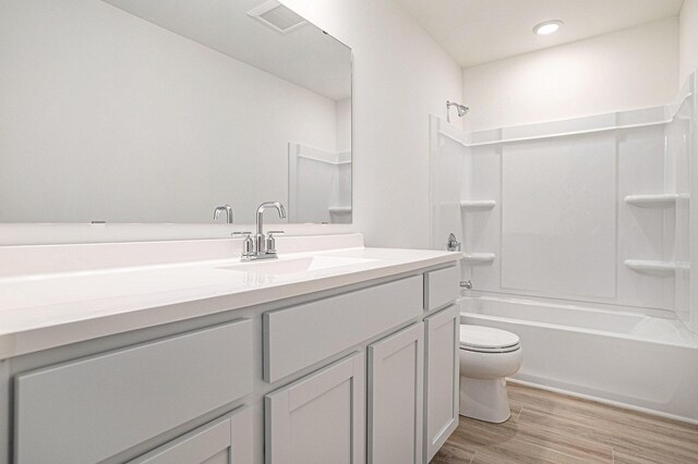 5227 Brinson Ln, Kalamazoo, MI 49009 - full bathroom with vanity, wood finished floors, shower / washtub combination, and recessed lighting