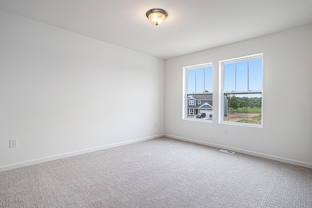 5227 Brinson Ln, Kalamazoo, MI 49009 - spare room featuring light carpet and baseboards