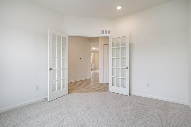 5227 Brinson Ln, Kalamazoo, MI 49009 - empty room featuring french doors, carpet, and recessed lighting