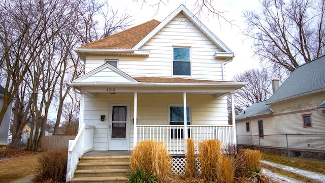 view of front of house featuring roof with shingles and covered porch