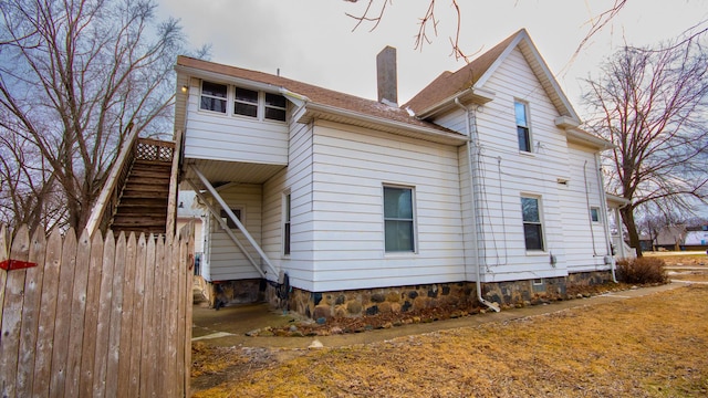 view of home's exterior with stairway and a chimney