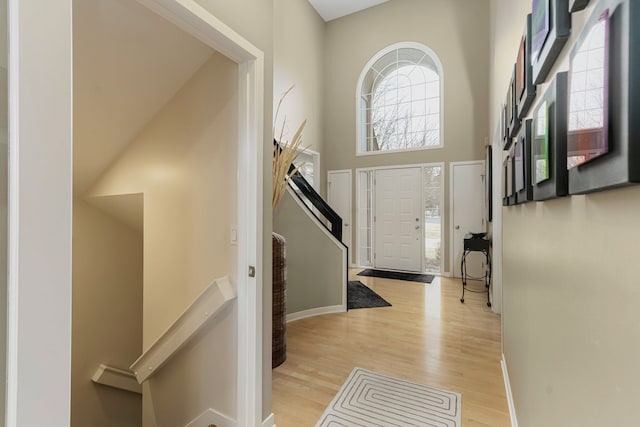 6264 Wildwood Ln, West Bloomfield, MI 48324 - entryway featuring light wood-style floors, baseboards, a towering ceiling, and stairway