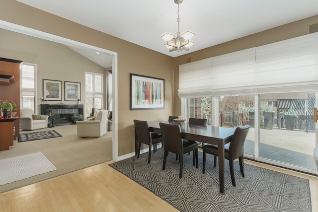 6264 Wildwood Ln, West Bloomfield, MI 48324 - dining area featuring a chandelier, wood finished floors, lofted ceiling, and baseboards