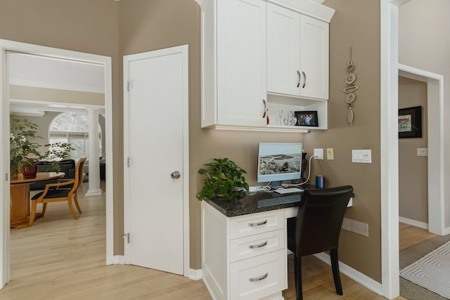 6264 Wildwood Ln, West Bloomfield, MI 48324 - office area featuring light wood-style floors, baseboards, built in study area, and decorative columns