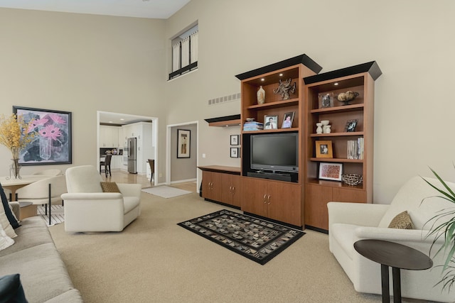 6264 Wildwood Ln, West Bloomfield, MI 48324 - living room featuring light colored carpet, a towering ceiling, and baseboards
