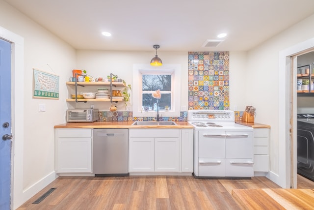 kitchen with visible vents, light wood-type flooring, a sink, range with two ovens, and dishwasher