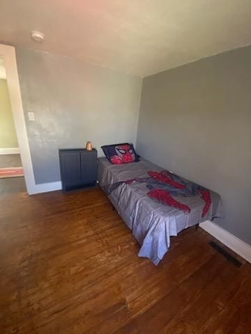 bedroom featuring wood finished floors and baseboards