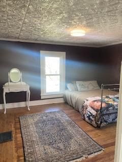 bedroom with wood finished floors and baseboards