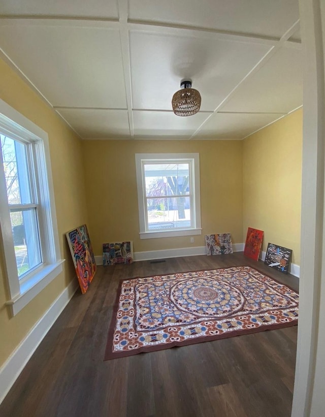 unfurnished room featuring baseboards and wood finished floors