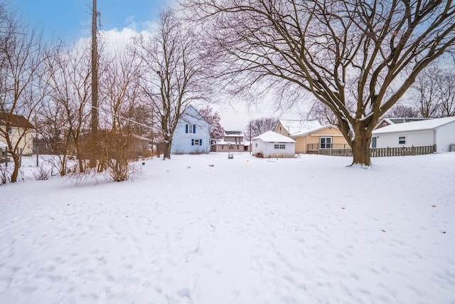 yard layered in snow with a garage