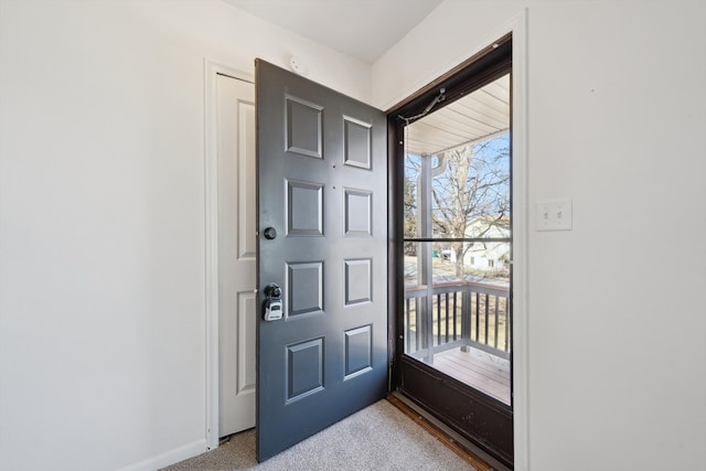 foyer with light carpet and baseboards