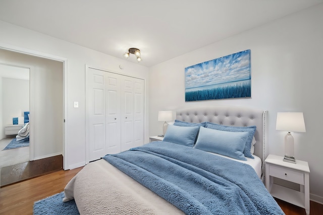 bedroom featuring a closet, baseboards, and wood finished floors