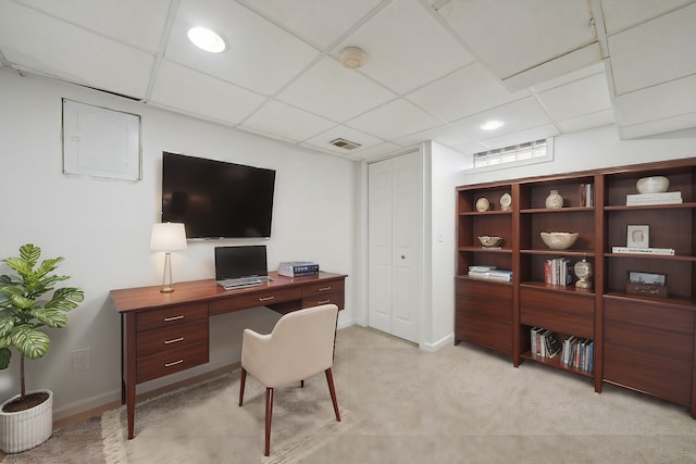 office space with light colored carpet, visible vents, a drop ceiling, and baseboards