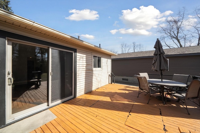 wooden deck featuring outdoor dining area