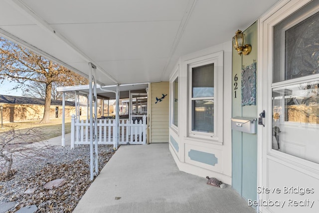 view of exterior entry with covered porch