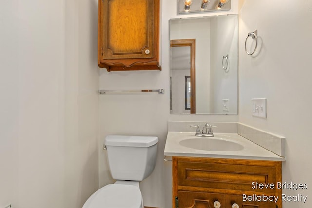 bathroom with toilet and vanity