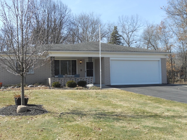 single story home featuring driveway, a front lawn, a porch, a garage, and brick siding