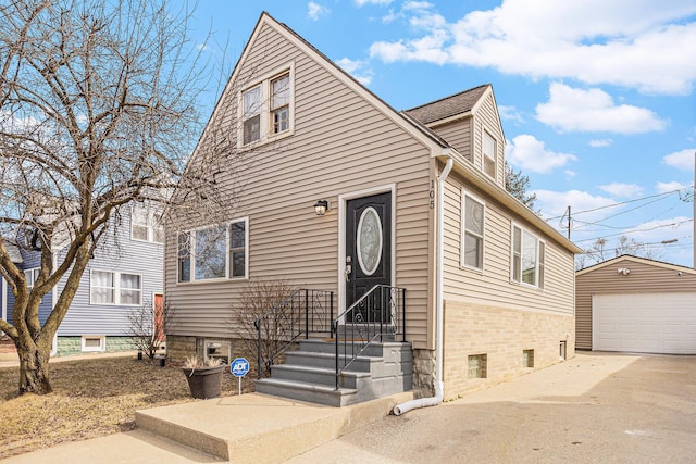 view of front of property featuring a detached garage and an outdoor structure