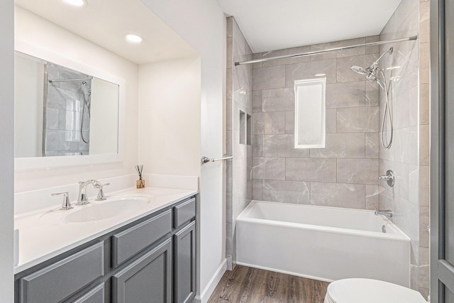 full bathroom featuring toilet, recessed lighting, shower / bathtub combination, wood finished floors, and vanity