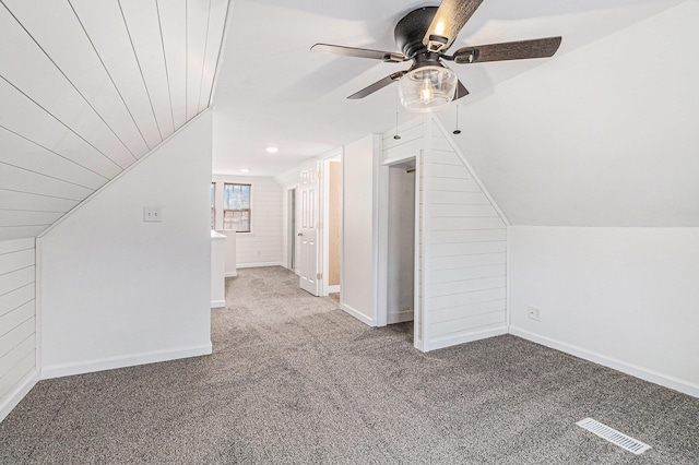 additional living space with a ceiling fan, visible vents, baseboards, lofted ceiling, and carpet flooring