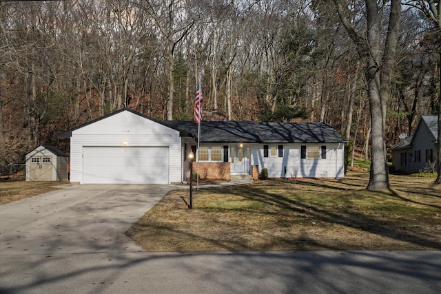 ranch-style house with concrete driveway, a garage, and a front yard