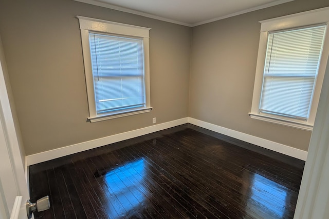 spare room featuring baseboards, dark wood-style flooring, and ornamental molding