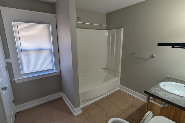 full bath with tile patterned flooring, washtub / shower combination, vanity, and baseboards