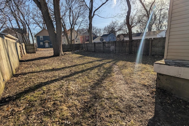 view of yard featuring a residential view and a fenced backyard