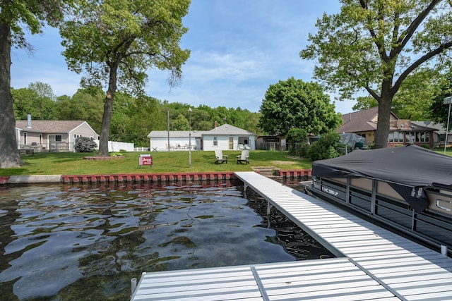 view of dock with a lawn