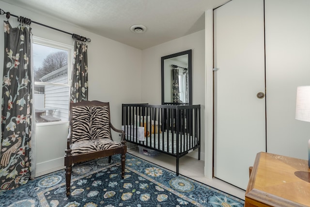 bedroom with visible vents and baseboards