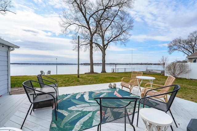 wooden terrace featuring a yard and a water view