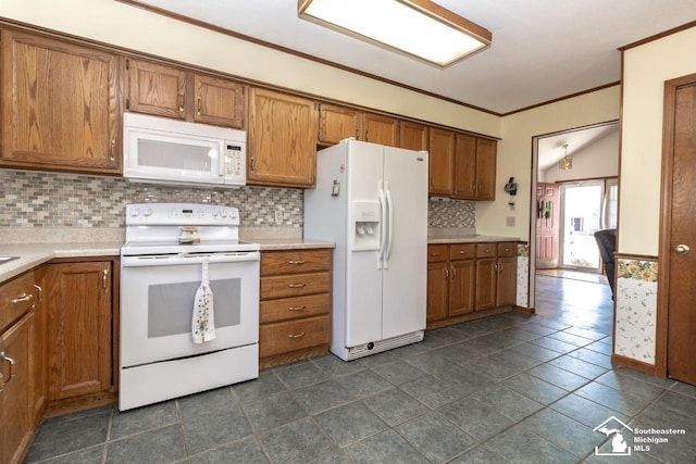 kitchen featuring white appliances, crown molding, brown cabinets, and light countertops