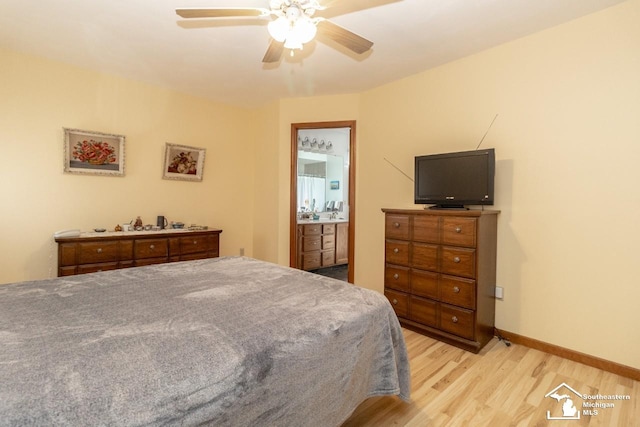 bedroom featuring light wood-style flooring, baseboards, ensuite bathroom, and ceiling fan