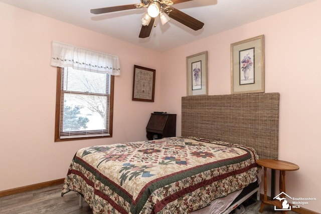 bedroom with wood finished floors, baseboards, and ceiling fan