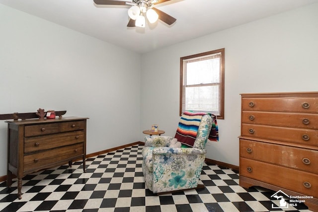 living area with tile patterned floors, baseboards, and a ceiling fan