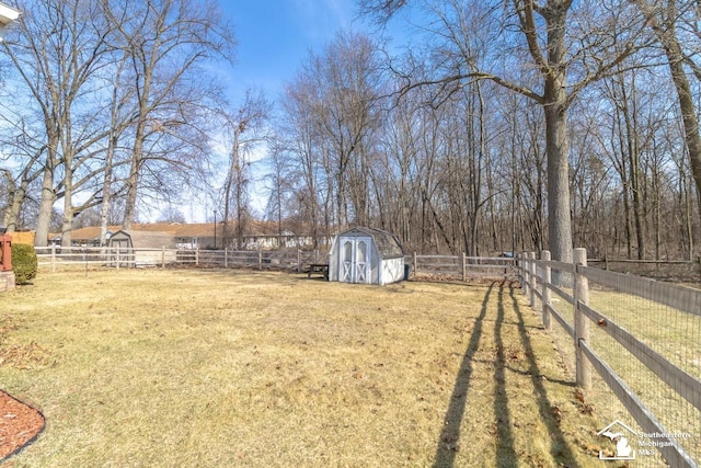 view of yard featuring an outbuilding, a shed, and a fenced backyard