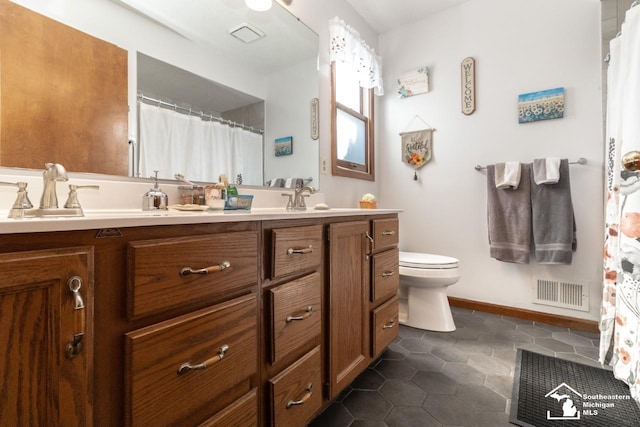 full bath featuring double vanity, toilet, visible vents, and a sink