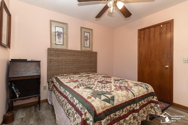 bedroom featuring a ceiling fan, wood finished floors, and baseboards