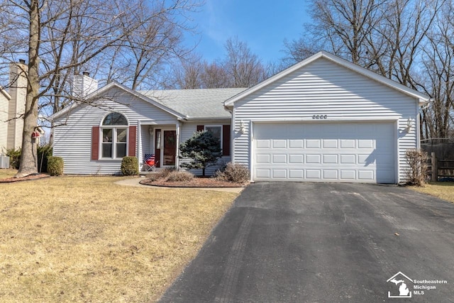 ranch-style house featuring aphalt driveway, an attached garage, a chimney, and a front yard