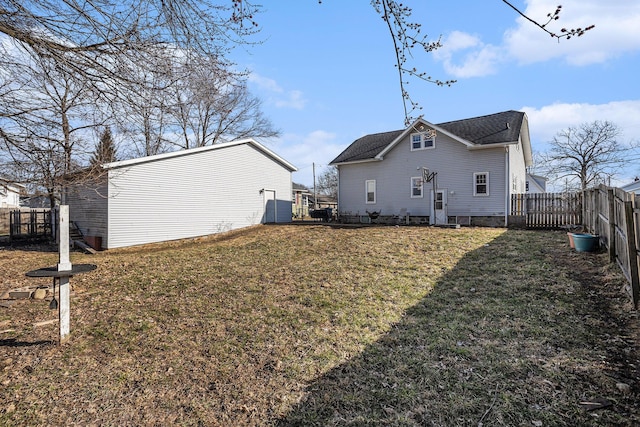 back of house with a lawn, a fenced backyard, and entry steps