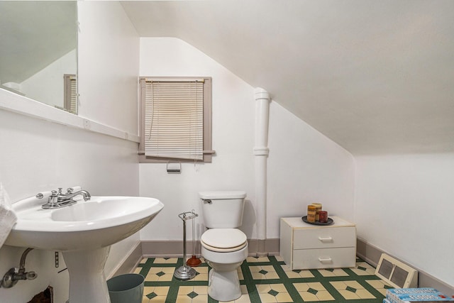 half bath with visible vents, toilet, baseboards, and vaulted ceiling